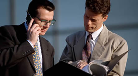 Two men reviewing marketing collateral